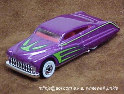Metallic-purple Hot Wheels Purple Passion with green-outlined graphics, a red interior, a white front wheel and covered rear wheels