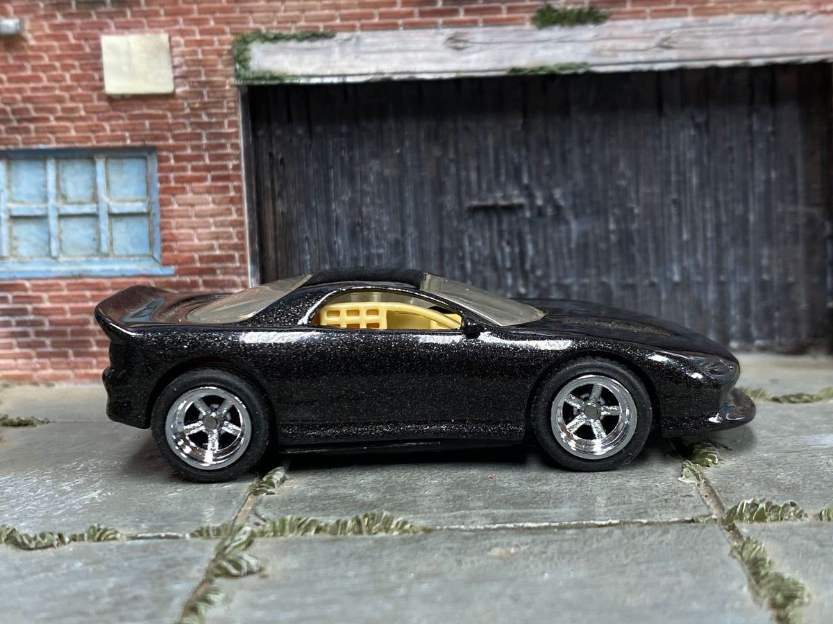 Black Pontiac Firebird custom Hot Wheels with chrome AMR wheels and rubber tires