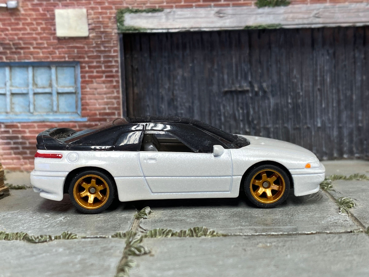 Pearl-white Subaru SVX custom Matchbox, left side with gold six-spoke wheels