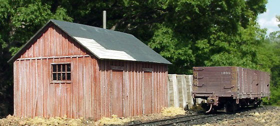 Banta Modelworks 6110 Ridgway Sandhouse O scale kit, assembled and painted model in a scene; freight car and scenery are separate.