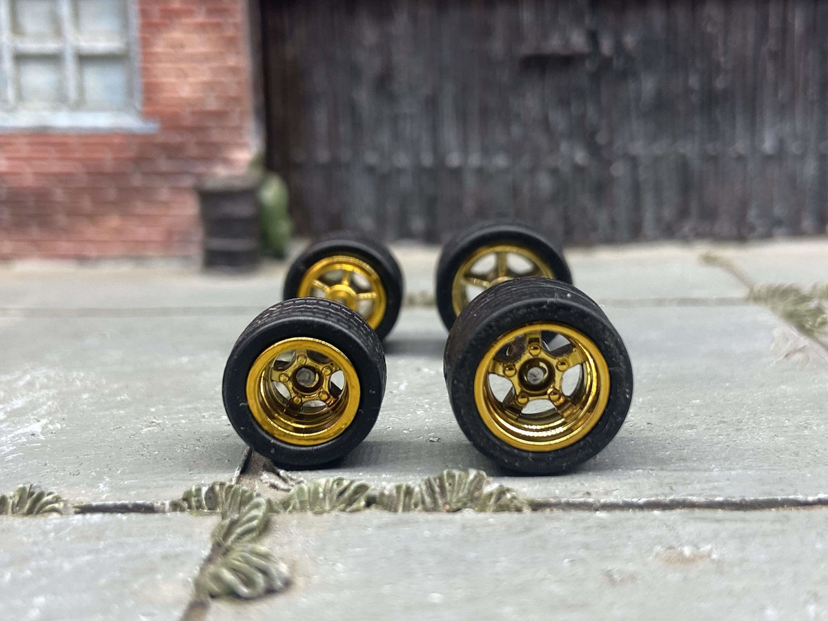 Gold five-spoke staggered replacement wheels with rubber tires for a custom diecast project