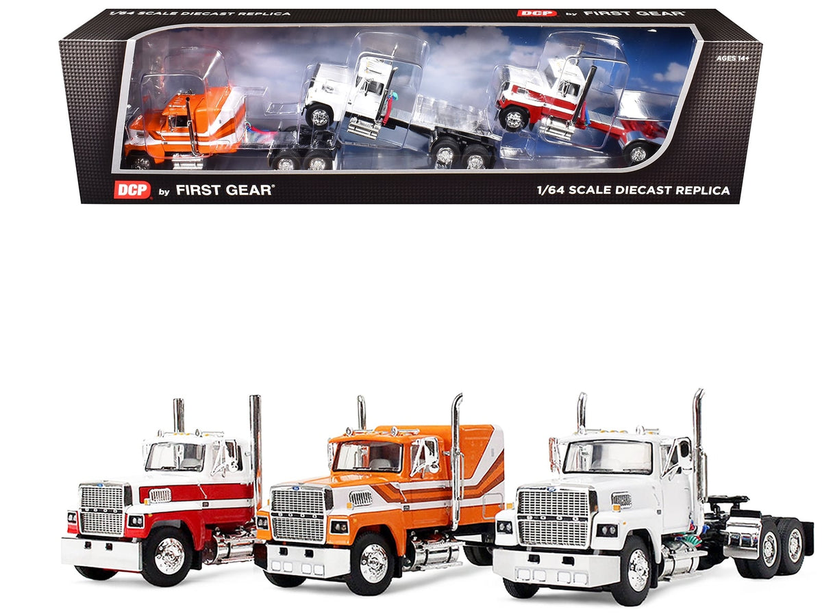 First Gear Ford LTL 9000 trio: white day cab, red-and-white day cab, and orange-and-white flat-top sleeper