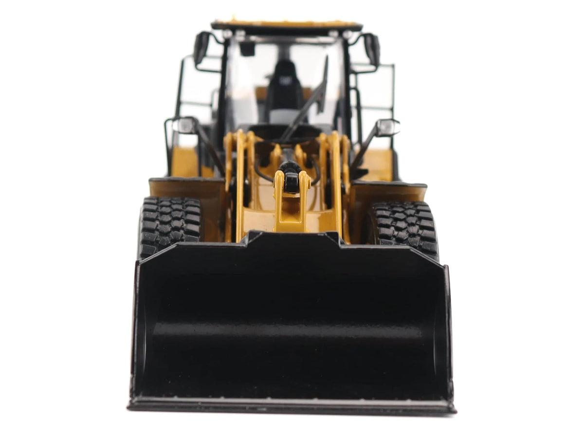 Front view of the yellow CAT 950 scale loader with its black bucket lowered
