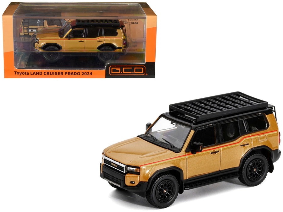 Gold metallic GCD Prado KS-075-580 with red side stripes and a black roof basket, shown as a finished 1:64 model