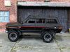 Loose Hot Wheels - 1988 Jeep Wagoneer - Satin Black and Red