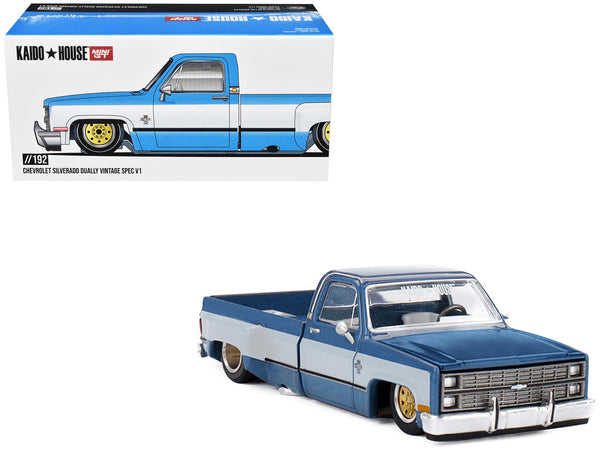 Kaido House x MINI GT 1:64 Chevrolet Silverado dually Vintage Spec V1 in light blue with white sides.