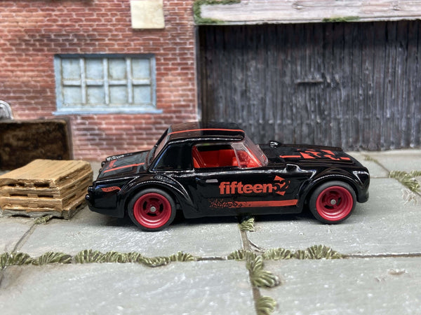 Black Fairlady 2000 custom Hot Wheels with red 4-spoke wheels