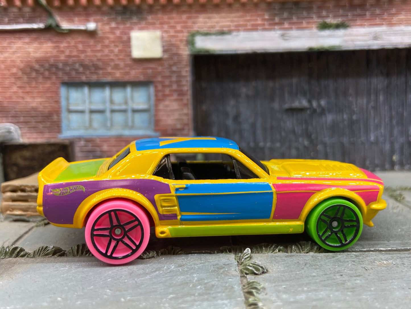 Loose Hot Wheels 1967 Ford Mustang GT Dressed in Yellow, Pink and Blue Art Car Livery
