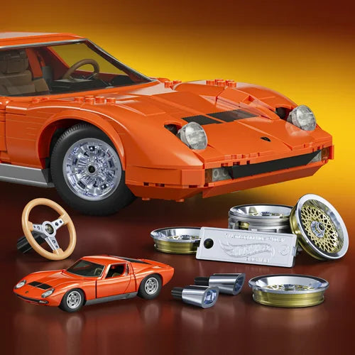 2026 JGJ19 — orange 1:64 Miura in the foreground beside the larger Brick Shop model