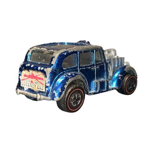 Blue Cockney Cab with Union Jack graphics and visible paint wear