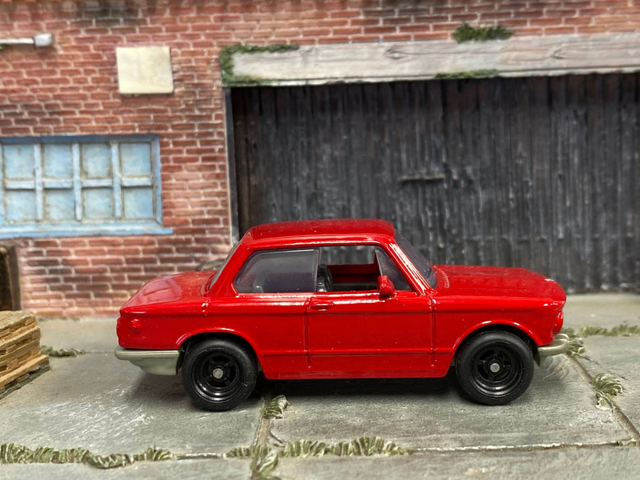 Red 1969 BMW 2002 custom Matchbox, left side with black four-spoke wheels