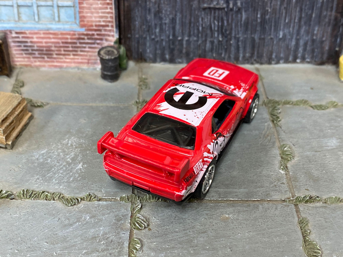 Disclosed Muncle Mikes custom Challenger Drift Car with replacement wheels, not an example of a counterfeit