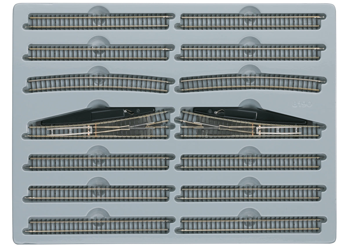 Märklin 8190 E extension set arranged in its tray with straight tracks, curves and two manual turnouts.