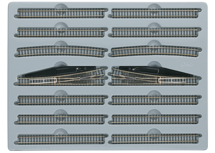 Märklin 8190 E extension set arranged in its tray with straight tracks, curves and two manual turnouts.