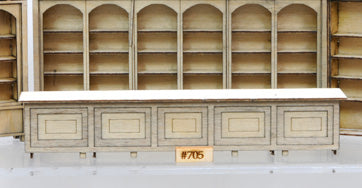 Banta Modelworks 705 O scale long counter top kit, assembled counter identified by the 705 label; background shelving is separate.