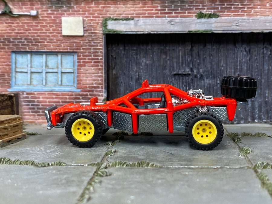 Red custom Hot Wheels dune buggy sand rail with yellow bead-lock wheels and rubber tires