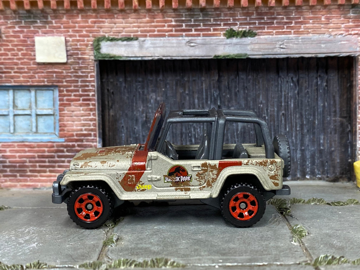 Matchbox Jeep Wrangler Jurassic Park Tour Jeep in Gold and Red Muddy, loose diecast car