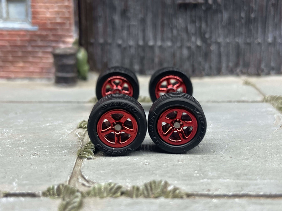 Four red five-spoke custom wheels with black tires