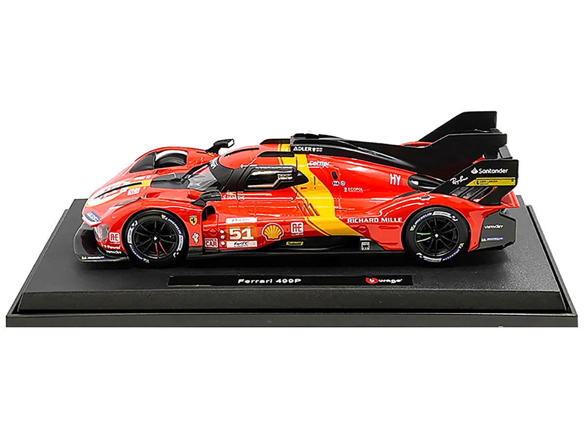 Red number 51 Ferrari 499P Bburago model on a black display plinth