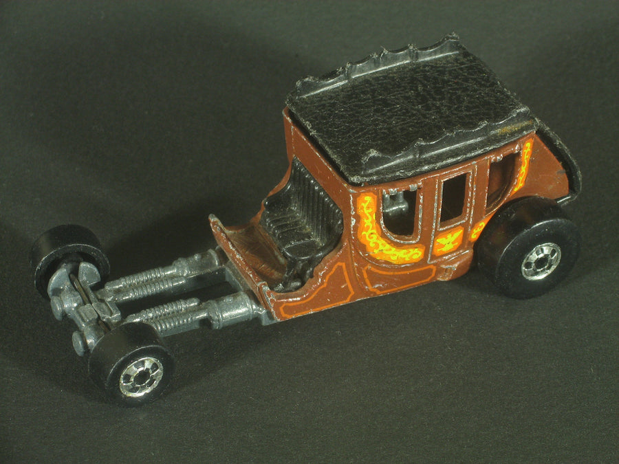 Brown Stagefright with black coach roof, orange and yellow decoration, long exposed front chassis and blackwall wheels