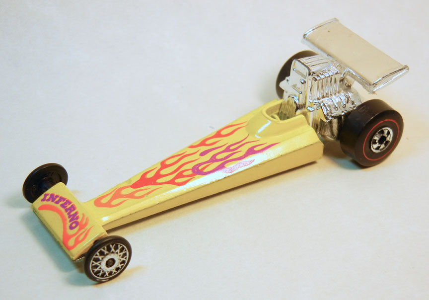 Yellow Inferno dragster with flame graphics, tiny front wheels, redline rear tires and exposed engine
