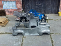 Stripped 1940 Ford Drag Truck body beside its matching donor assembly
