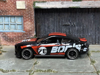 Black and red BORLA Mustang GT custom with chrome-rimmed wheels, left-side view
