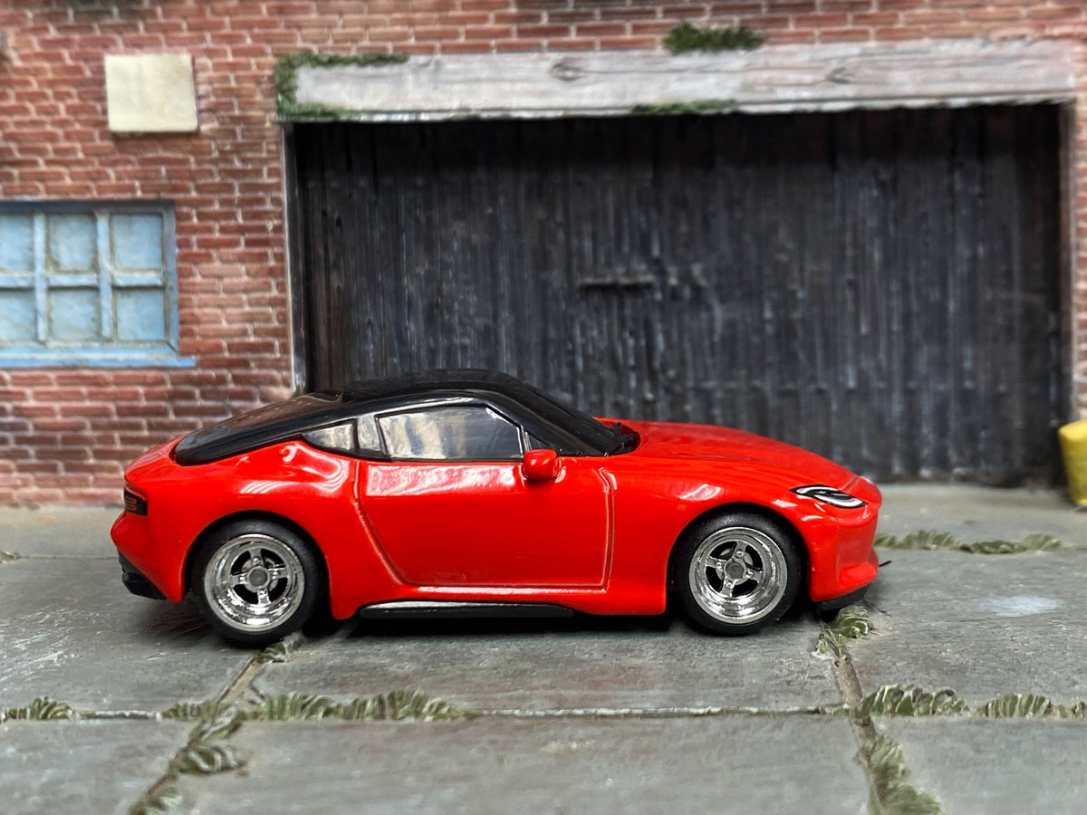 Red custom 2023 Nissan Z with chrome 4-spoke wheels, right-side view