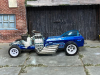 Metallic-blue custom Rigor Motor dragster with Birdhouse graphics, left-side view
