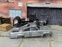 Disassembled 1973 Jeep J10 DIY kit with stripped body and chassis components