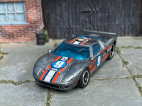 Custom Ford GT-40 showing number 9 hood graphics and black-and-chrome wheels, front three-quarter view