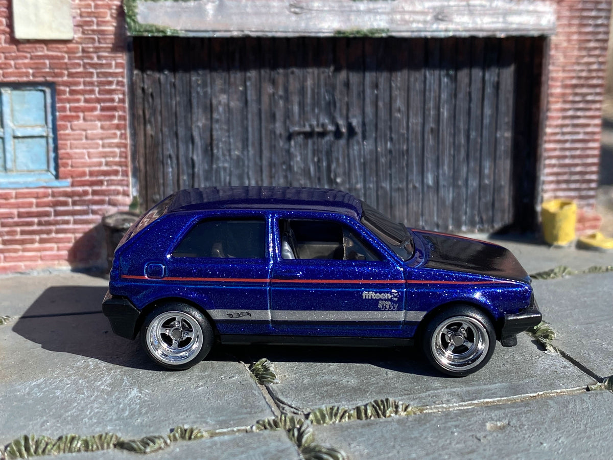 Metallic-blue Volkswagen Golf custom Hot Wheels, left side with chrome four-spoke wheels