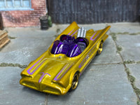 Gold and purple custom Batman Batmobile with silver exhausts, front three-quarter view
