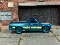 Metallic-blue custom Mazda REPU with lightning graphics and blue wheels, right-side view