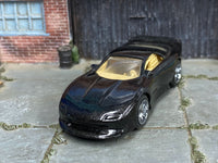 Black custom Pontiac Firebird with tan interior, front three-quarter view