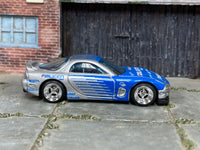 Silver-and-blue 1995 Mazda RX-7 custom Hot Wheels, front three-quarter view