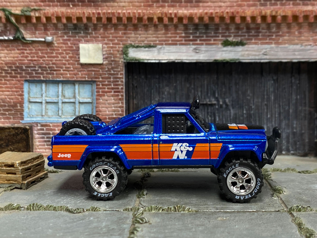 Blue 1973 Jeep J10 custom with K&N graphics, right-side view