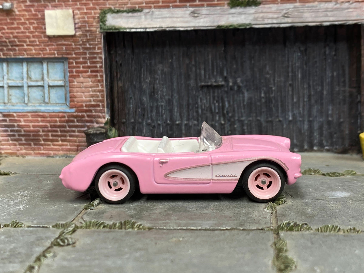 Pink-and-white custom 1956 Chevrolet Corvette with pink wheels, right-side view
