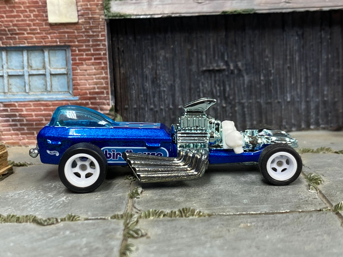 Metallic-blue custom Rigor Motor dragster with white wheels, right-side view
