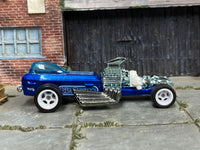 Metallic-blue custom Rigor Motor dragster with white wheels, right-side view