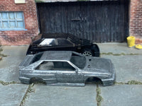 Stripped 1987 Audi Quattro diecast body beside its matching donor assembly