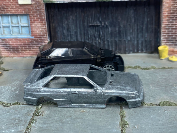 Stripped 1987 Audi Quattro diecast body beside its matching donor assembly
