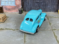 1940 Ford Fat Fender custom with chrome AMR wheels, side view