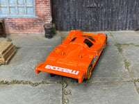 Custom Mazda 787B orange die-cast car, side view