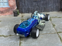 Blue custom Rigor Motor dragster showing chrome engine and white wheels, rear view
