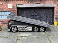 Satin-black Hot Wheels rollback with rubber tires, alternate angle