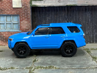 Blue 2018 Toyota 4Runner custom Matchbox, left side with knobby rubber tires