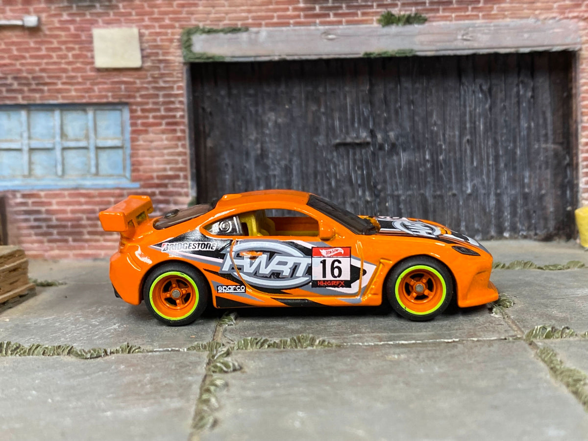 Custom Toyota GR86 Cup in orange with orange-and-green mag wheels, front three-quarter view