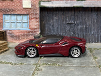 Dark-red Ferrari SF90 custom showing chrome wheels and rubber tires
