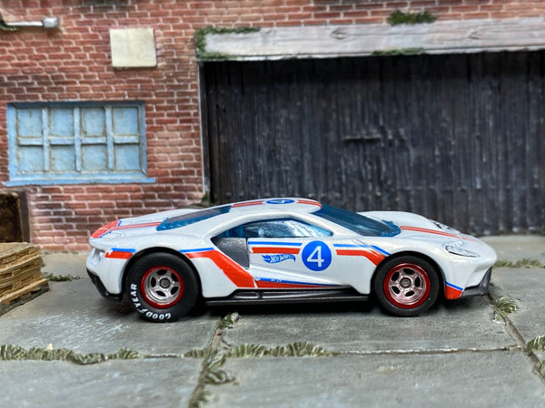 White custom 2017 Ford GT with red-and-blue graphics and number 4, right-side view